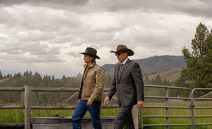 Two men walk on a ranch in Yellowstone.