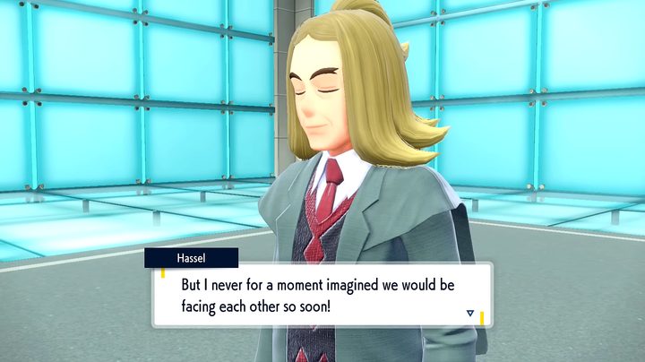 A trainer in a suit smiling.
