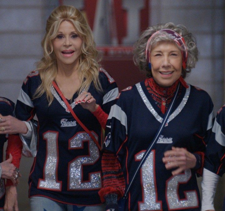 Four women lock arms and walk in a scene from 80 for Brady.
