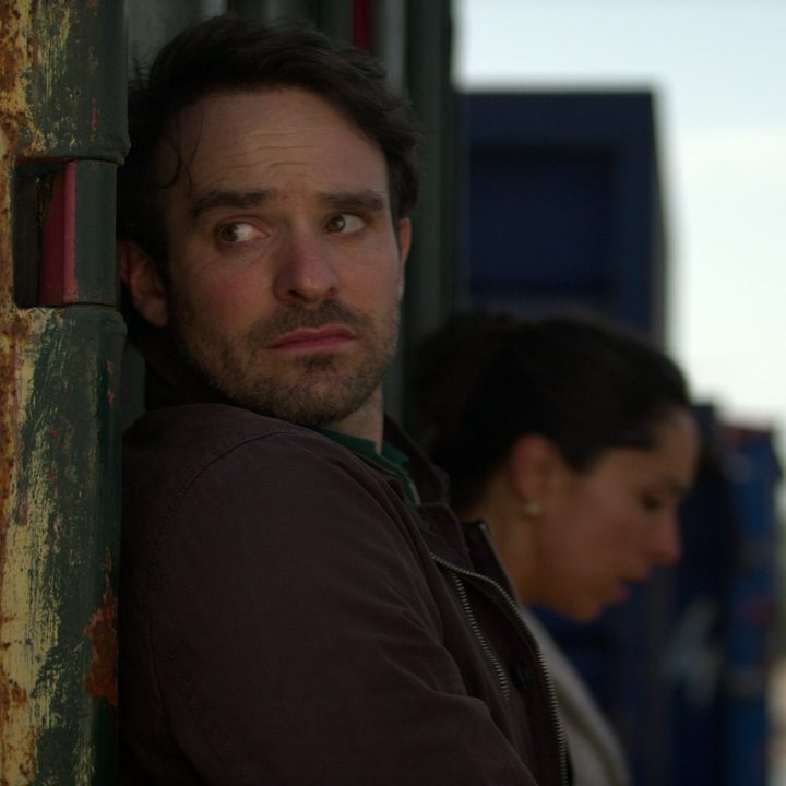 Charlie Cox stands against the wall in a scene from Treason.