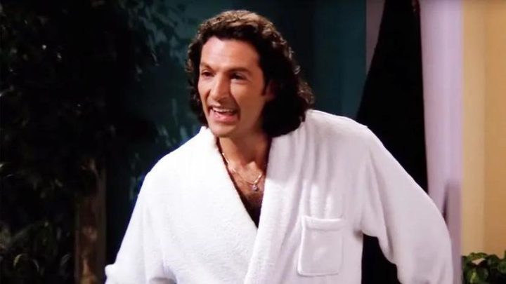 Paolo smiling while standing in Friends.