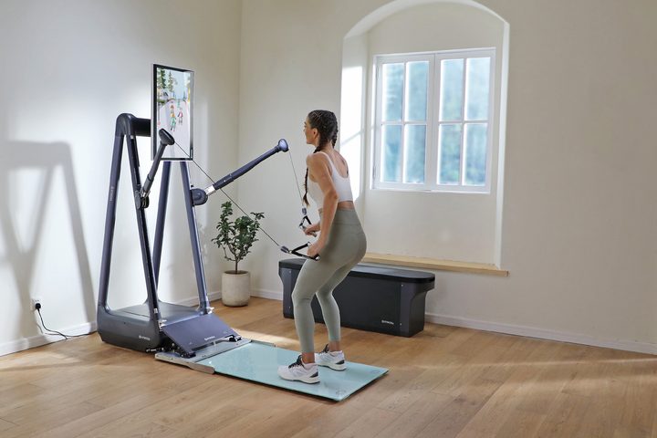 A woman using the Gymera Smart Home Gym at home.