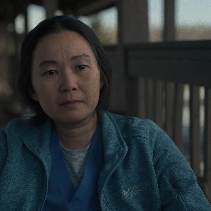 Hong Chau sits and stares in a scene from The Whale.