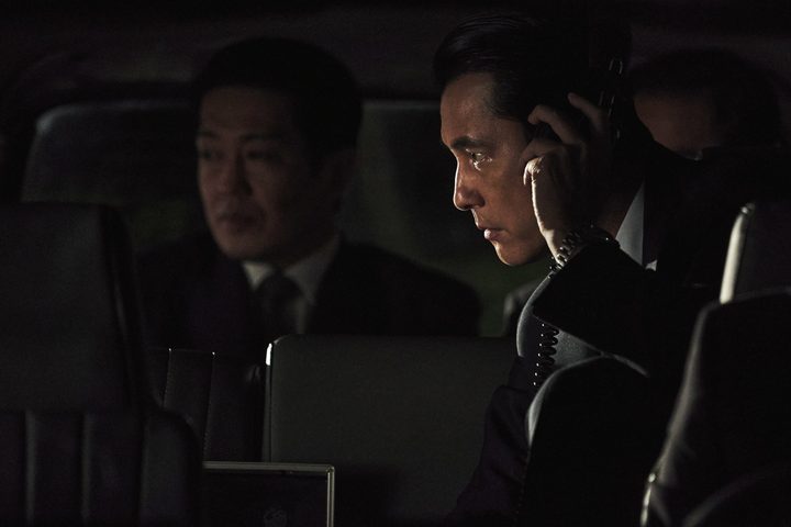 Jung Woo Sung wears a pair of surveillance headphones in Hunt.