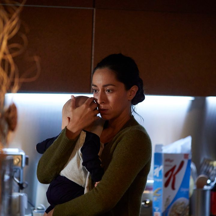 A woman holds her baby n a scene from Lullaby.