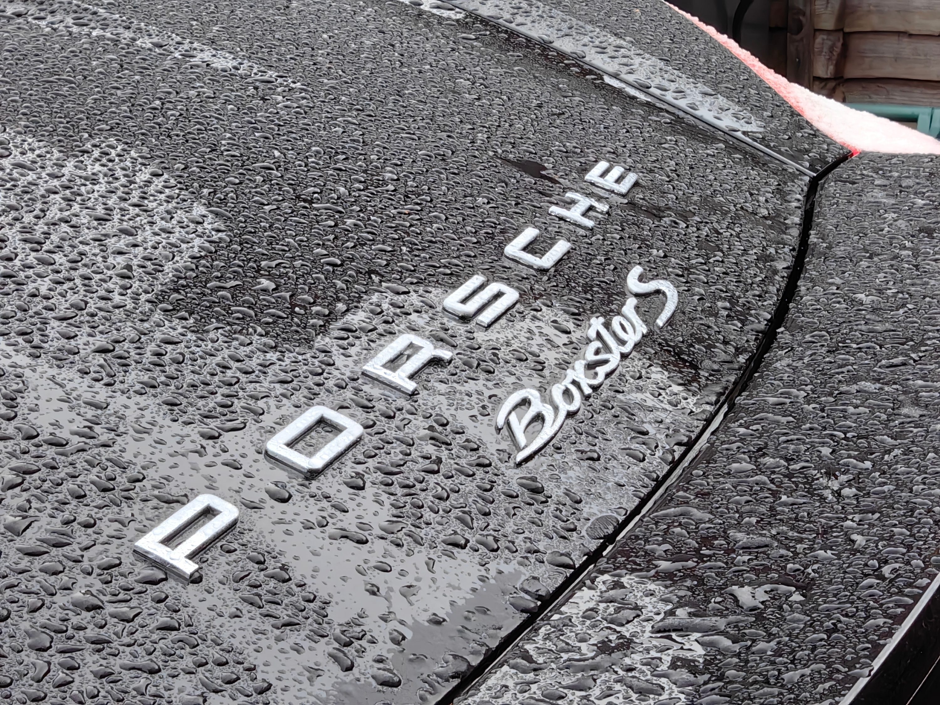 Mate 50 Pro bokeh photo of a Porsche logo.