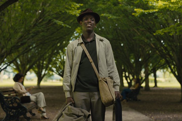Michael Ward stands between two rows of trees in Empire of Light.