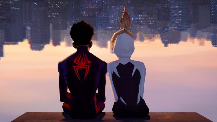 Two teens hang upside in a scene from Spider-Man: Across the Spider-Verse.