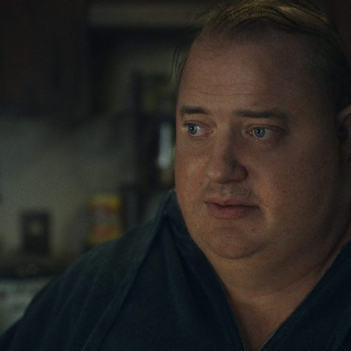 Brendan Fraser sits and stares in a scene from The Whale.