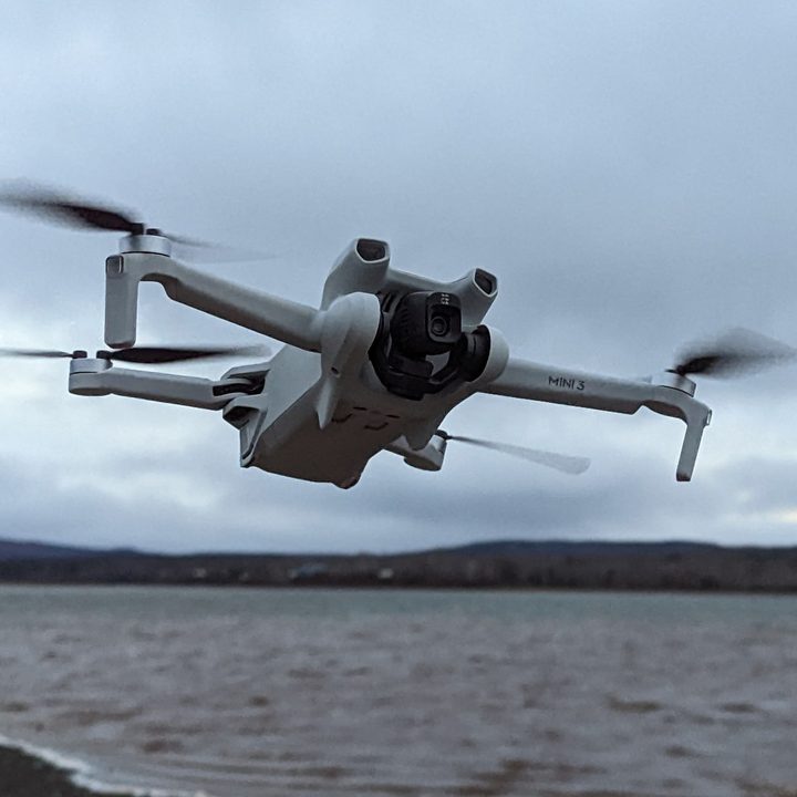 The DJI Mini 3 is shown taking off.