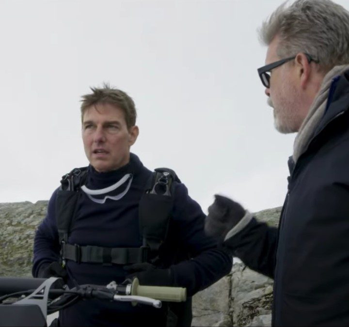Tom Cruise talks with Christopher McQuarrie on the set of Mission: Impossible 7.