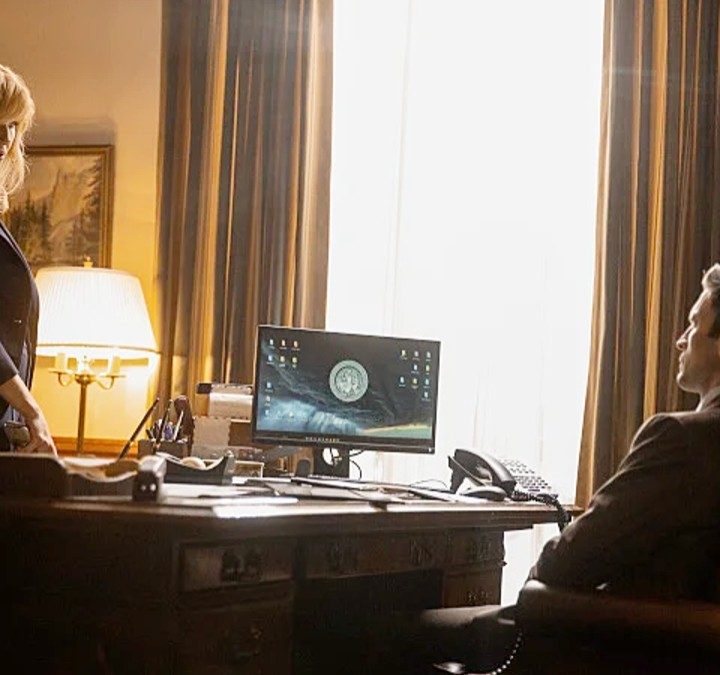 A man and a woman talk in an office in Yellowstone.