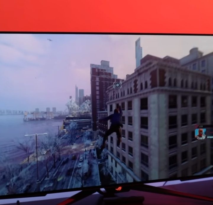 The Asus PG42 on a desk against a glowing red background.