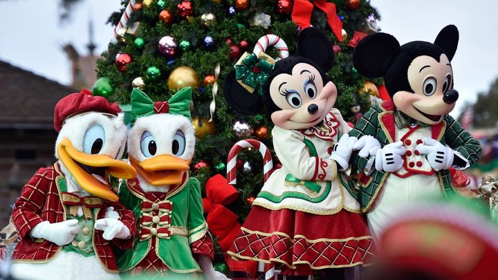 Mickey and Minnie smile on a float in Disney's Magical Parade.