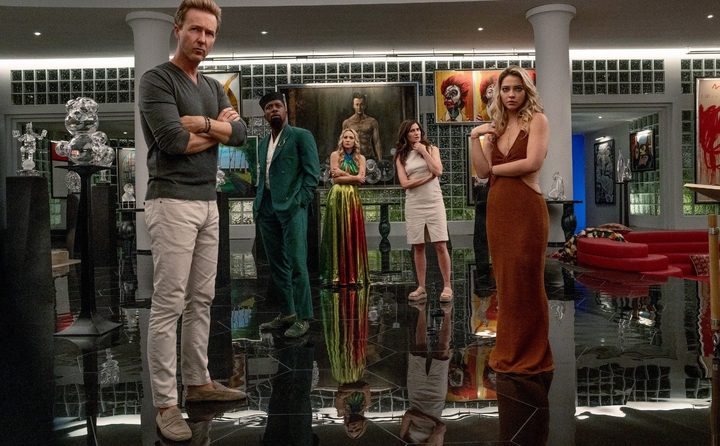 A group of people look suspicious in Glass Onion.