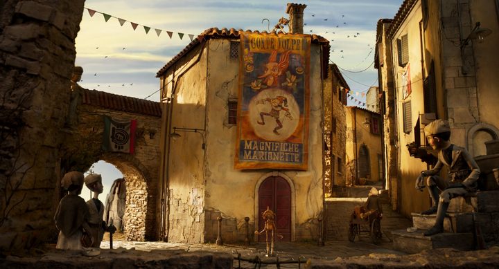 Pinocchio stares up at an advertisement on the side of a building.