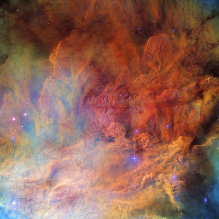 A portion of the open cluster NGC 6530 appears as a roiling wall of smoke studded with stars.