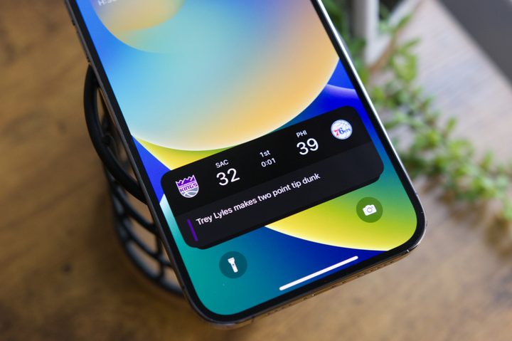 Sports scores for an NBA game displayed on an iPhone's lock screen.