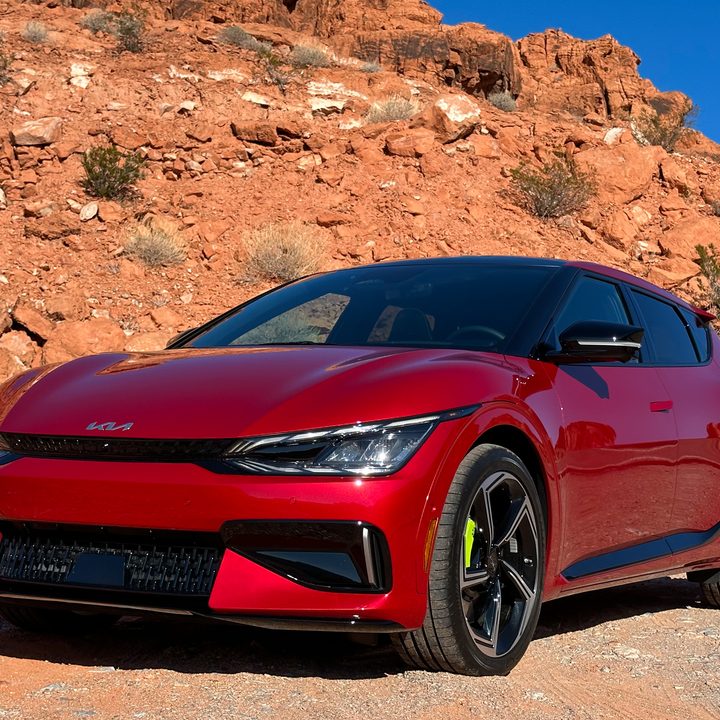 Front three-quarters view of a 2023 Kia EV6 GT in a desert setting.