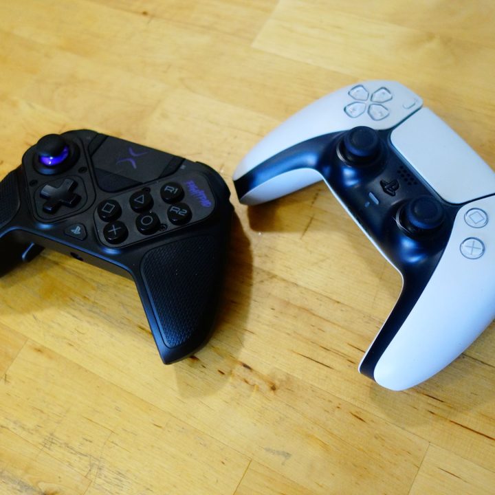 A Victrix Pro BFG sits on a table next to a DualSense.