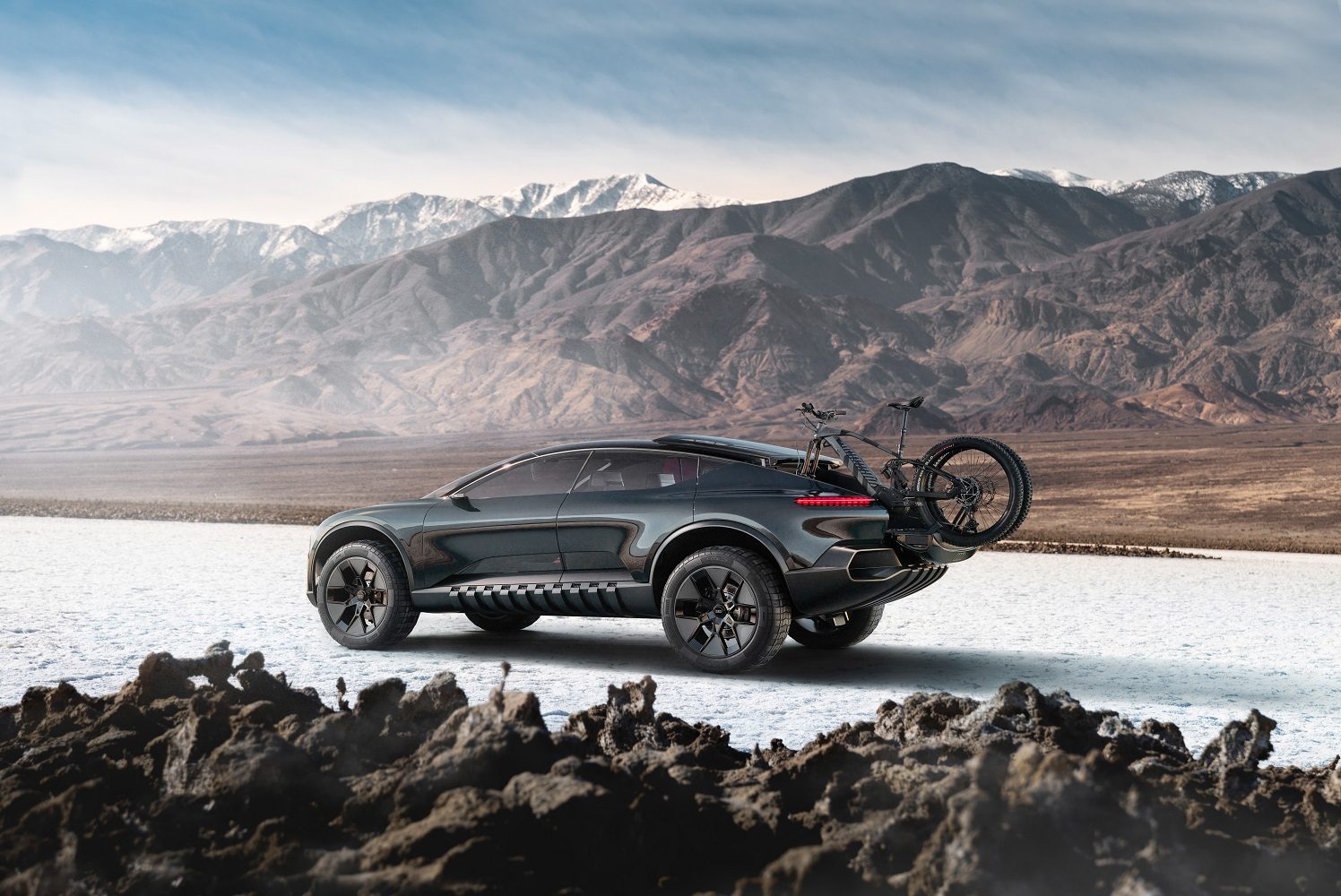 Audi ActiveSphere concept car in a mountainous setting with a bike on the rear rack.
