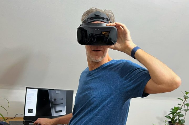 Alan Truly turns toward the camera, wearing the Varjo Aero VR headset.