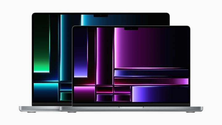 The 14-inch MacBook Pro with M2 chips sitting in front of the 16-inch MacBook Pro with M2 chips.