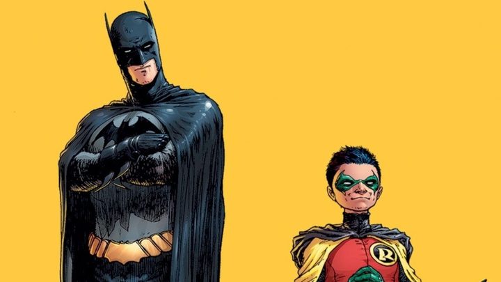 Batman and Robin standing side by side against a yellow background in DC Comics.