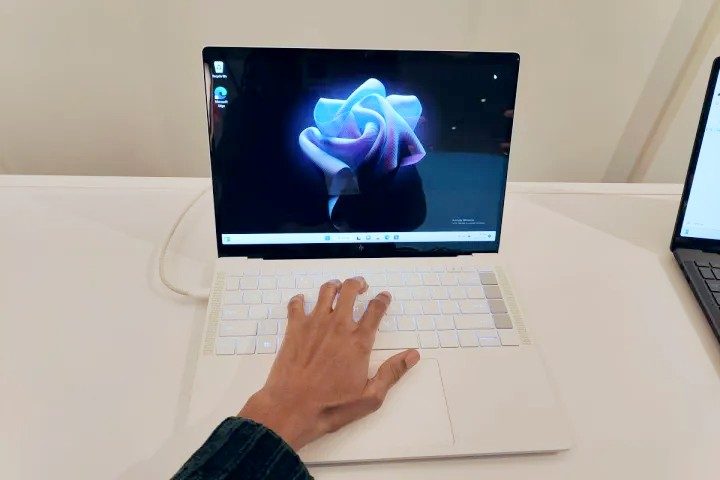 My hand on the keyboard of the HP Dragonfly Pro.