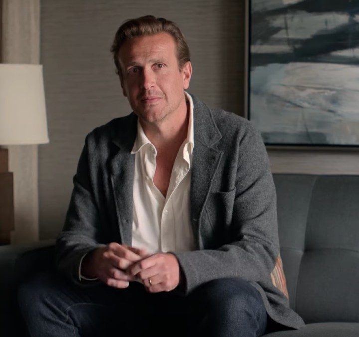 Jason Segal sits on a couch in Shrinking.
