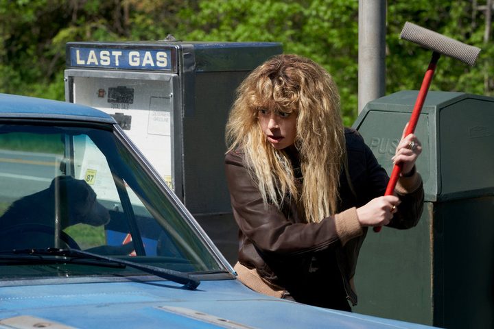 Natasha Lyonne holds a gas station windshield wiper in Poker Face.