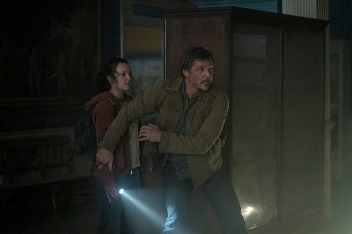 Pedro Pascal stands in front of Bella Ramsey in The Last of Us.