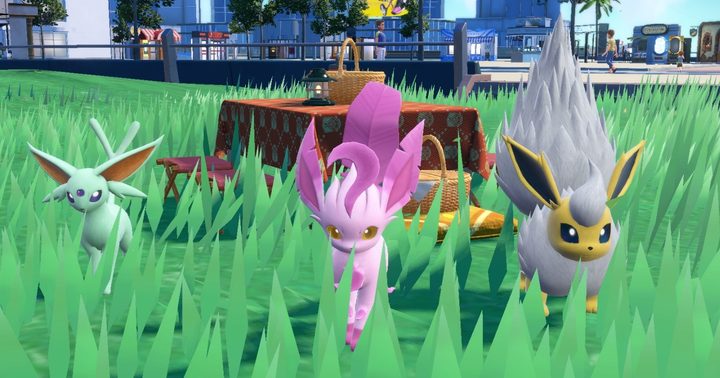 Three shiny Pokémon by a picnic.