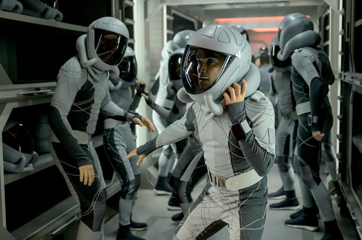 A man puts on his space helmet in a scene from The Ark.