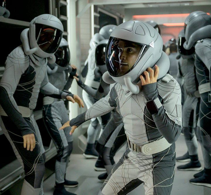 A man puts on his space helmet in a scene from The Ark.