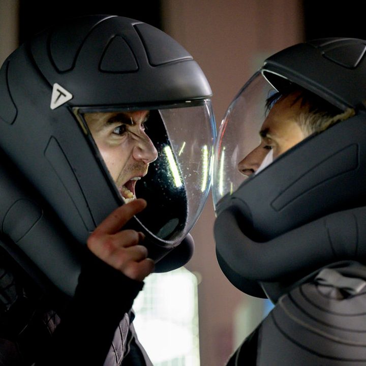 A man in a spacesuit screams at another man.