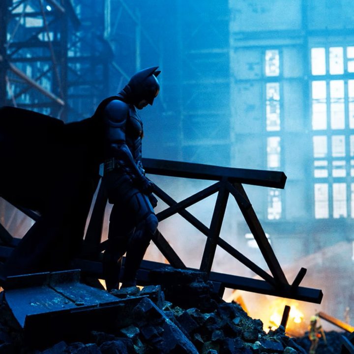 Batman brooding over a wreckage in The Dark Knight.