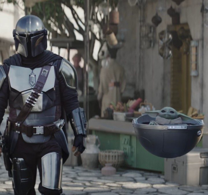 A Mandalorian walks next to Grogu in The Mandalorian season 3.