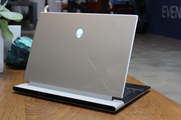 The lid of the Alienware x14 R2 on a wooden table.