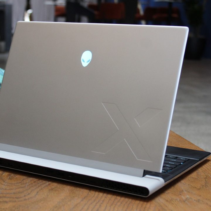 The lid of the Alienware x14 R2 on a wooden table.
