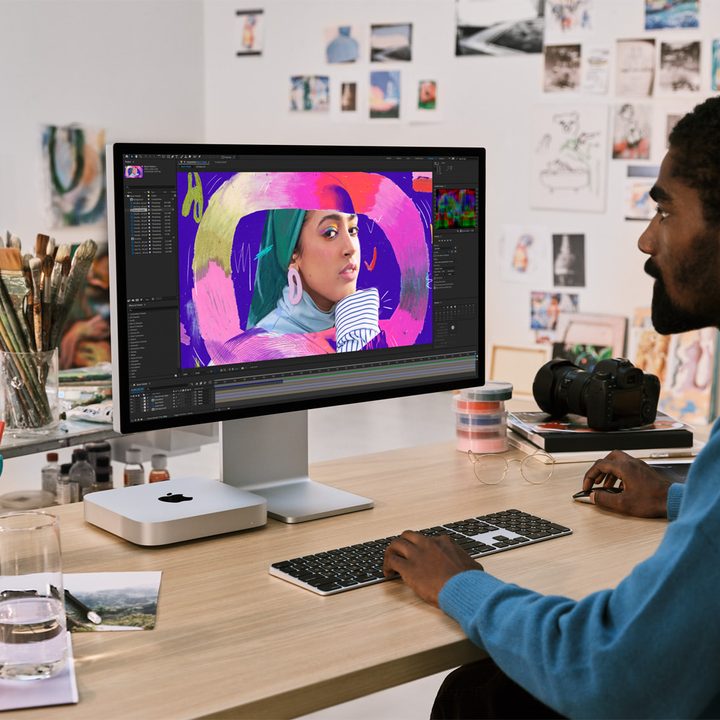 Someone editing photos on the M2 Mac Mini.