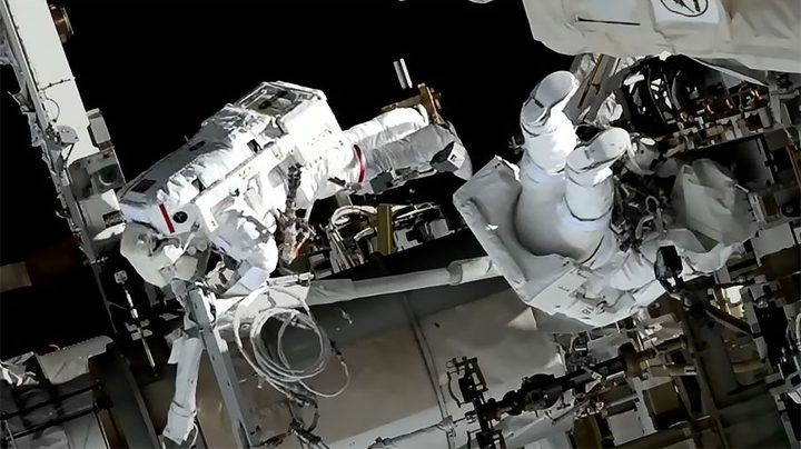 Spacewalkers (from left) Koichi Wakata and Nicole Mann are pictured installing hardware on the space station preparing the orbiting lab for its next roll-out solar array.