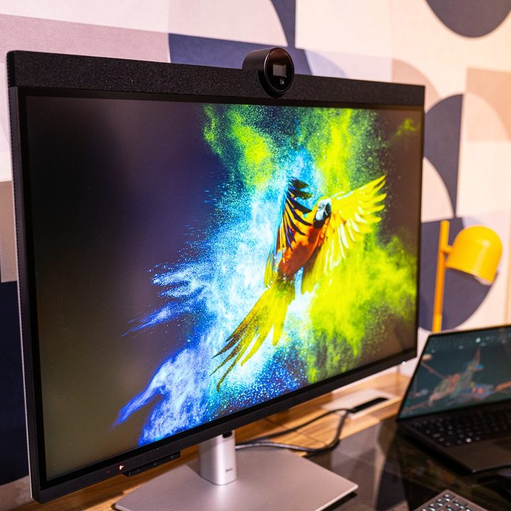 The Dell UltraSharp 6K monitor connected to a laptop on a desk.