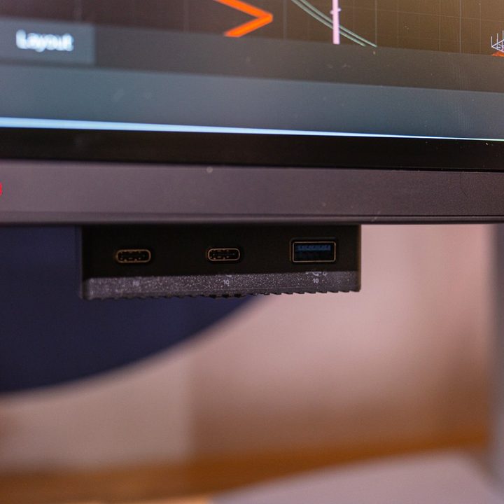 The flip-down ports under the Dell UltraSharp 6K monitor.