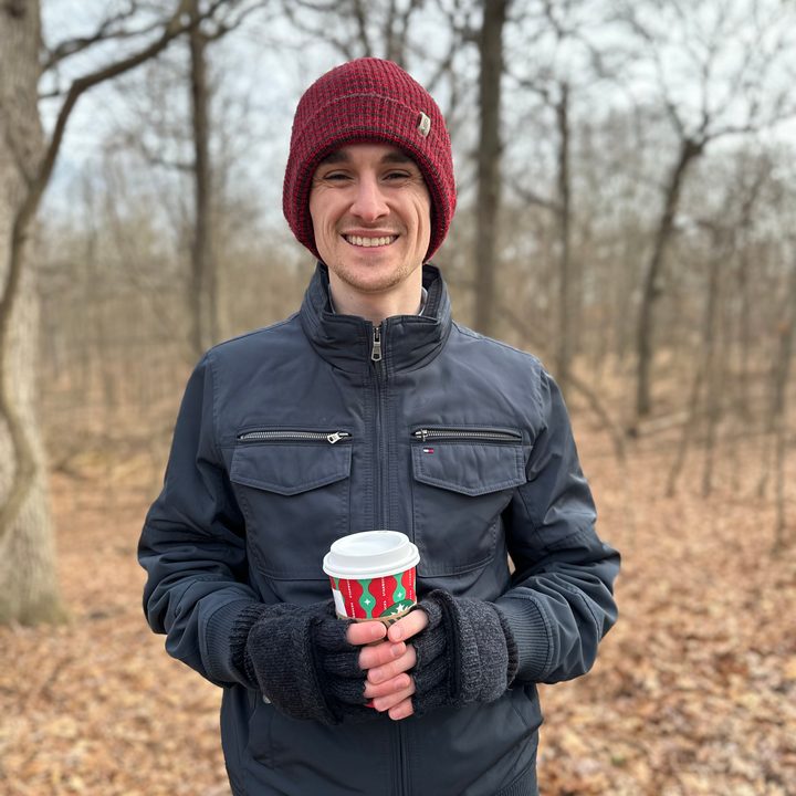 Portrait mode photo of Joe Maring outside on a nature trail.