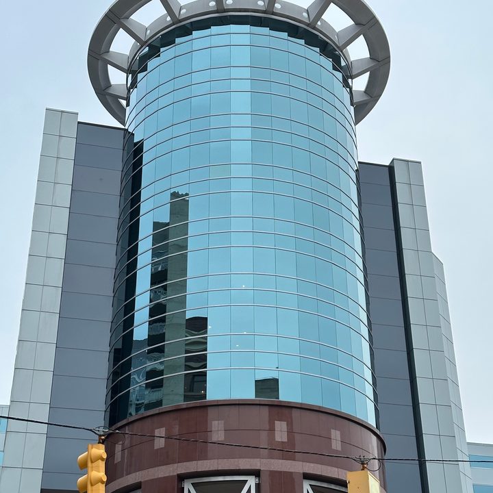 Zoomed in photo of a circular, glass building.
