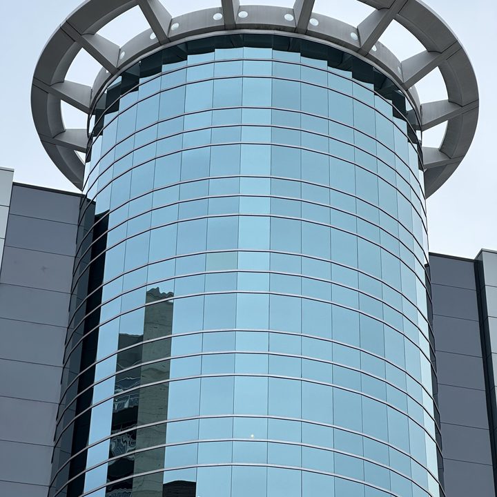 Zoomed in photo of a circular, glass building.
