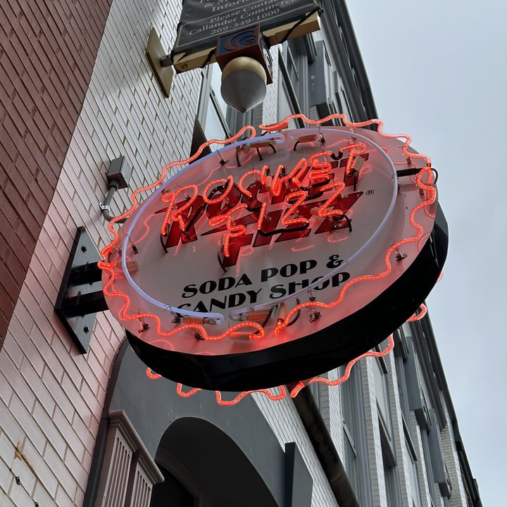 Photo of a neon sign for a soda shop.