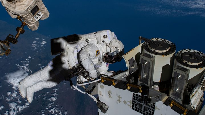 A photo of Expedition 68 Flight Engineer and NASA spacewalker Josh Cassada on Dec. 22, 2022, preparing a roll-out solar array for its deployment on the International Space Station's Port-4 truss segment as the orbiting lab flew 264 miles above the Indian Ocean off the coast of South Africa.