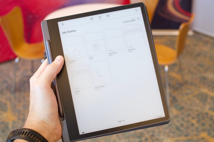 Holding the Lenovo Smart Paper.